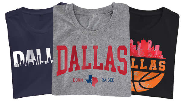 A collection of Dallas-inspired t-shirts in navy, gray, and black, each featuring distinctive Dallas graphics, including skyline silhouettes and basketball themes.