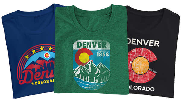 Banner showcasing three Denver-themed t-shirts: navy with a colorful circular 'Denver Colorado' motif, green with a mountainous 'Denver 1858' landscape, and black featuring a red mosaic style 'Denver Colorado' design.