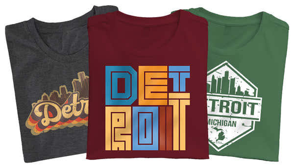 A trio of Detroit-inspired t-shirts in charcoal, maroon, and green, featuring bold graphics and lettering that celebrate the city of Detroit.