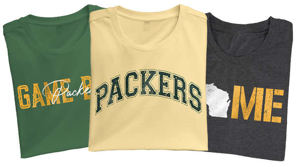 A series of Green Bay-inspired t-shirts in green, gold, and charcoal, each with bold typography celebrating the local sports culture.