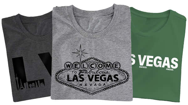 A wide banner displaying three Las Vegas-themed t-shirts; one with large 'LV' initials, one with the classic 'Welcome' sign, and one in green stating 'Las Vegas Raised. Proud.