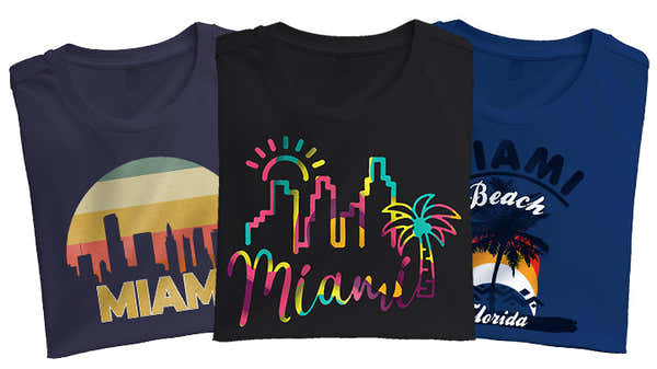 Three Miami-themed t-shirts; navy with retro sunset and 'MIAMI' skyline, black with neon 'Miami' and palm tree design, and royal blue with 'Miami Beach Florida' and a palm tree graphic.