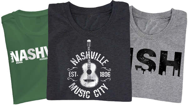 Three Nashville-themed t-shirts; green with 'NASHVILLE' in bold white lettering, charcoal with a guitar and 'Nashville Music City Est. 1806', and heather gray with 'NSH' in a silhouette skyline design.