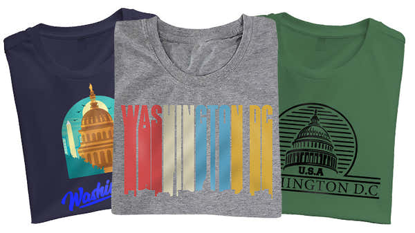 Variety of Washington D.C. t-shirts in navy, gray, and green, showcasing graphics of the Capitol building and colorful stripes with the city name.